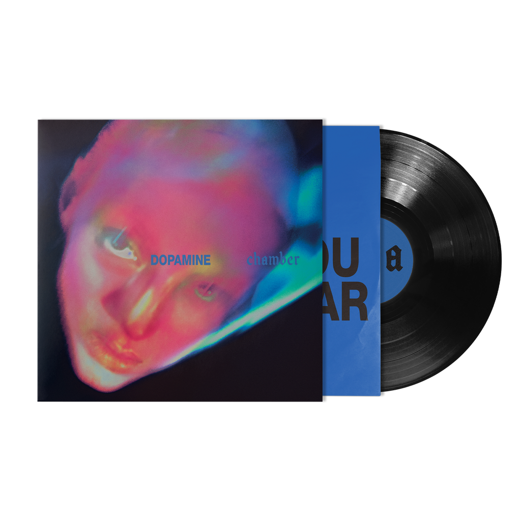 Vinyl cover with neon colorful graphic of a female on a black background with bright blue inner sleeve with bold black text. 